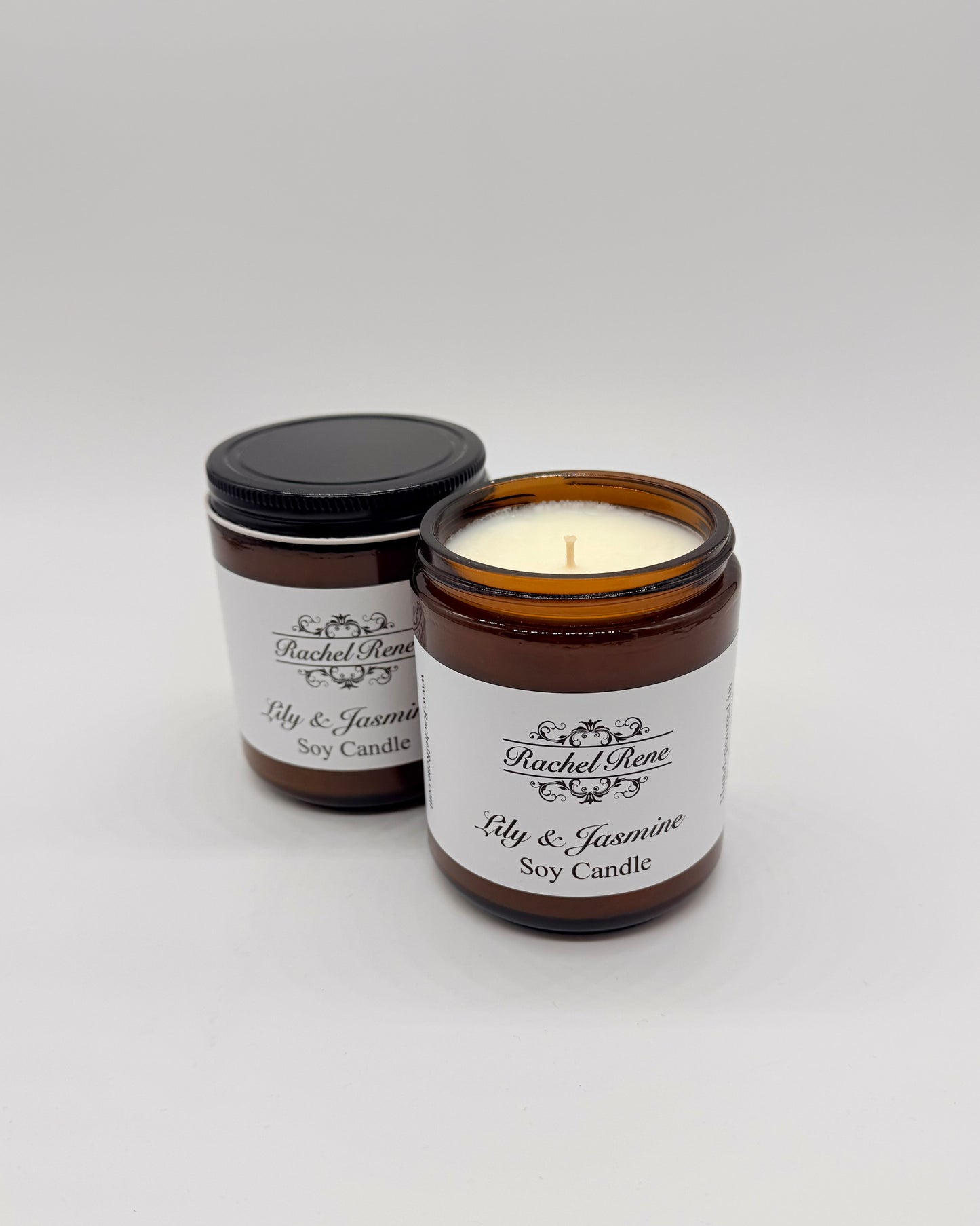 Two Lily & Jasmine soy candles in glass jars with labels on a white background
