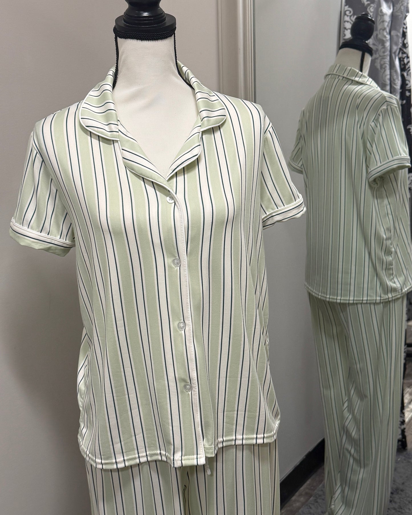 Green and white striped pajama set on a mannequin against a neutral background
