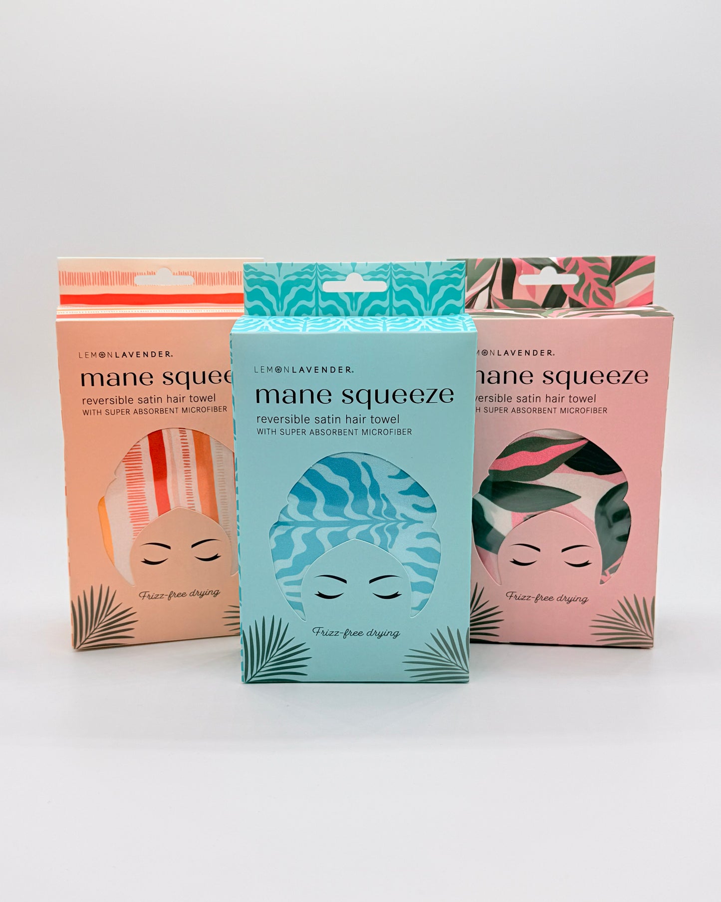 Three boxes of 'mane-squeeze' hair towels on a white background