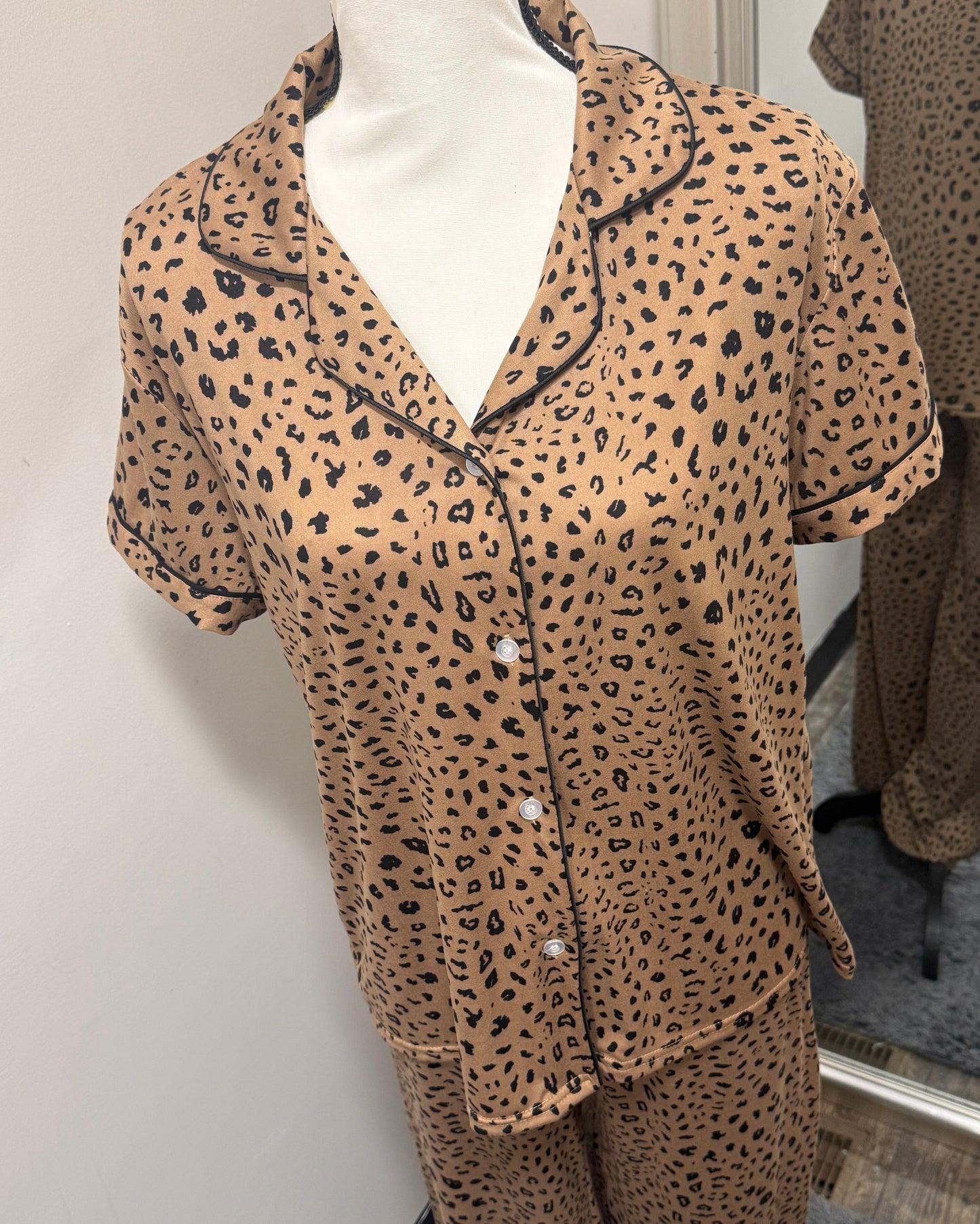 Leopard print pajama set on a mannequin against a neutral background