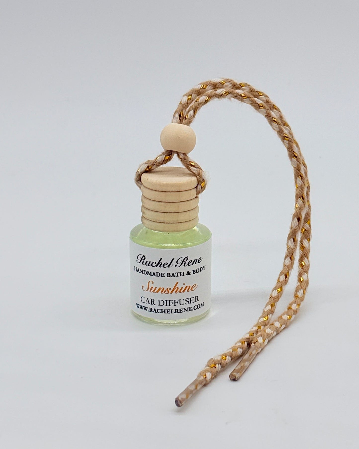 Car diffuser with wooden topper and a braided rope string on a white background