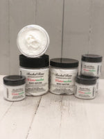Watermelon scented body mousse that is white in color in a clear jar with a black lid 