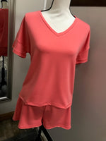 A coral v-neck short sleeve tee.