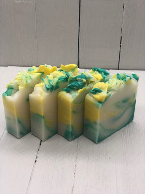Soap bars with fluffed tops. White with a blend of teal and yellow.