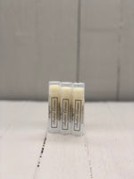 Pale yellow lip butter in a clear tube labeled "Butter Creme"