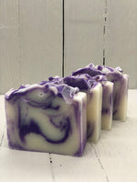 A white soap bar with purple swirls.