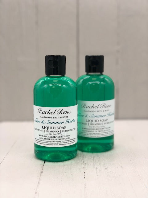 A clear bottle with teal liquid soap inside. A white label reads "Aloe & Summer Herbs".