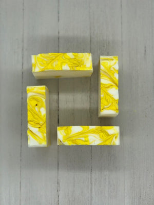 A white soap bar with yellow swirls.
