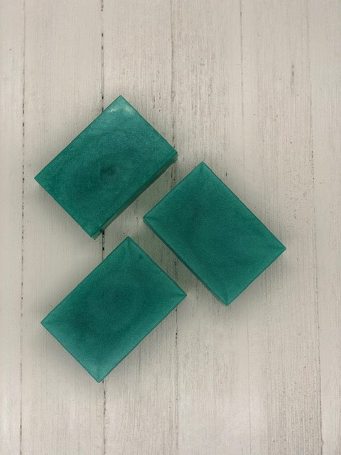 Three teal rectangular soap bars.